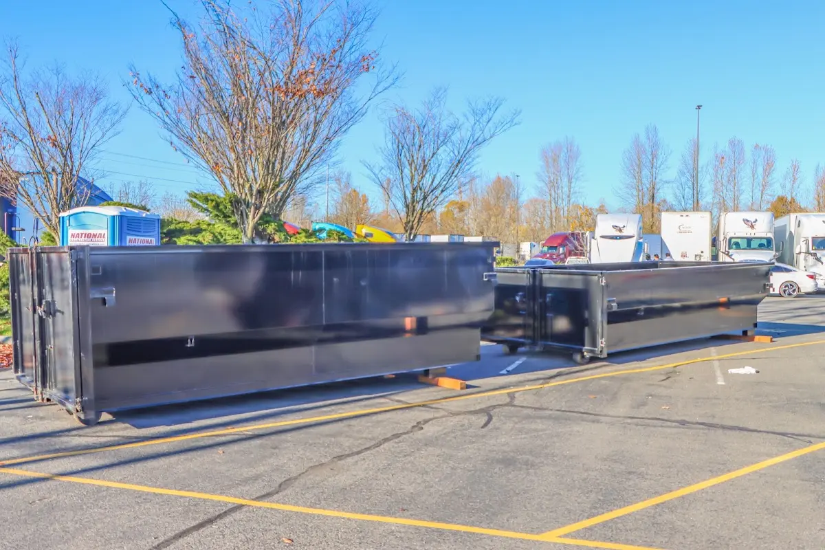 Professional dumpster rental service with roll-off container on residential driveway in Onondaga